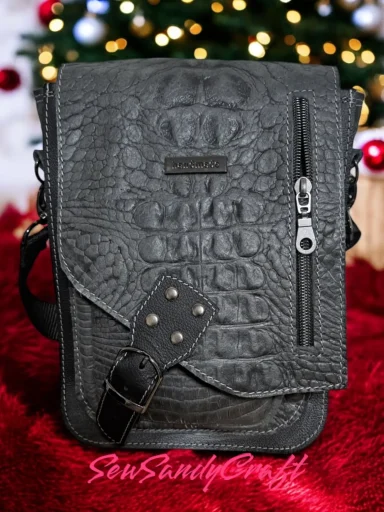 Gray textured crossbody bag with zippered pocket.