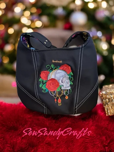 Black handbag with embroidered skull and roses design